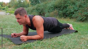Fitness man doing plank exercise outdoor. Male athlete doing plank workout in park. Stamina guy workout. Handsome athlete muscle concentration. Boy push up balance Stock Video