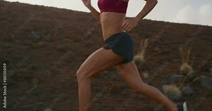 Strong young woman running strong outdoors pushing hard for her cardio workout training day, fit woman with strong abs and muscular biceps