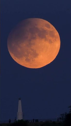 Jet flies through moon over Griffith Observatory