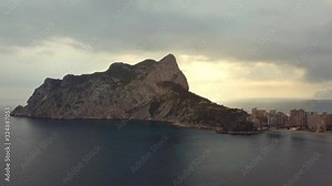 Aerial view big rock near Parque natural del Penon de Ifach in Calpe, symbol of Calpe town, 4k footage. Province of Alicante, Costa Blanca, Spain