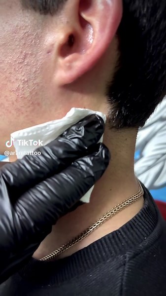 Fresh Black Cross Tattoo: Close-Up Neck Art