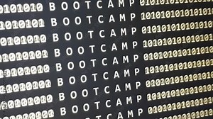 BOOTCAMP word on scrolling software development monitor with binary code. Programming or hacker device screen. Stock Video