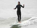 Leighton Meester catches some Malibu waves in a black wetsuit