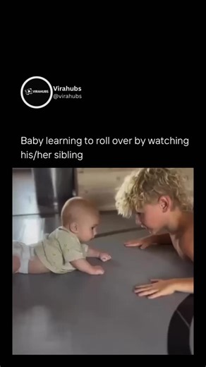 @virahubs | lesson in learning by watching. A baby in a green onesie lies still, eyes fixed on an older sibling with curly hair rolling back and forth... | Instagram