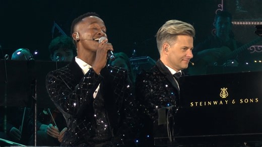 Charl du Plessis and Katlego Maboe share a tender take on “Smile” — a timeless reminder of resilience and hope. #AfroSymphonic #RMBStarlightClassics Rights secured by CAPASSO. | RMB - Corporate & Investment Banking