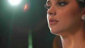 Close-up of a woman's lower face and neck with soft lighting, highlighting her lips and jawline.
