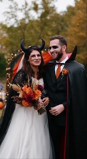A wedding with a bride and groom in Halloween costumes laughing