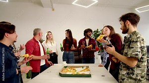 Group of coworkers having fun during office party. Happy friends drink beer and eating pizza
