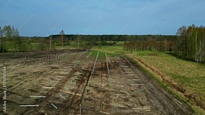 Installing posts erect a solar panel power system - pullback aerial reveal Stock Video