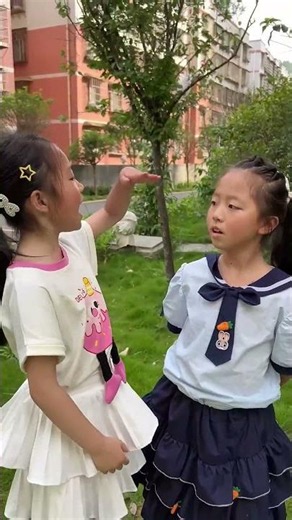 A height boosting hack—the younger sister is now taller than the older one!