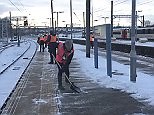 Video: Workers clear snow off train platform ready for commuters in Norwich | Daily Mail Online