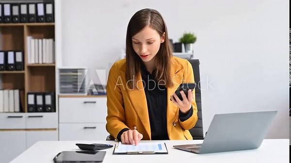 Young businesswoman working with working notepad, tablet and laptop documents talking on the smartphone, tablet and laptop video call tax, report