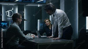Male and Female Special Service Agents Interrogate Young Suspect in Cyber Crimes, Officer Looses Temper and Threatens Accused while Questioning. Dark Interrogation Room.