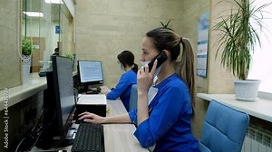 Medical practitioner answering phone calls and scheduling appointments in hospital