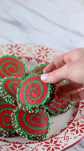 Christmas Pinwheel Cookies 🍪 These vintage inspired cookies are so festive and easier than you may think to make! For a beginner friendly version- use store bought sugar cookie dough and prepare the same way. INGREDIENTS: -3 cups flour -1 tsp baking powder -1/2 tsp salt -1 cup unsalted butter, room temp -1 cup sugar -1 tbsp vanilla extract -2 large eggs -red and green food coloring -sprinkles 1. In a large bowl, whisk together the flour, baking powder, and salt. Set aside. In a separate bowl, b