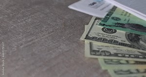 IRS 1040 tax return form with currency US dollar banknotes close-up