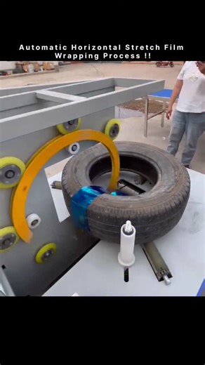 World_War on Instagram: "This post captures automatic horizontal stretch film wrapping machine, specifically designed for wrapping circular or coil-shaped products like the tire in the image. The process is called automatic horizontal stretch film wrapping. Machine Operation and Features Process: The product (in this case, a tire) is placed on a set of horizontal rollers or a conveyor system. A roll of stretch film on a rotating ring then moves around the circumference of the product, wrapping i