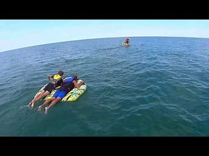 Yamaha Jetski pulling the Tube Hydroslide Arsenal Shaped Deck Tube 64" two person