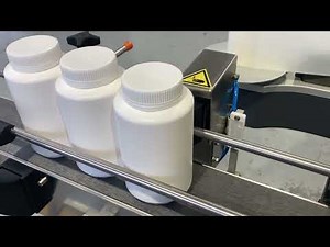 Labelling system for wrap-around label application onto plastic jars.