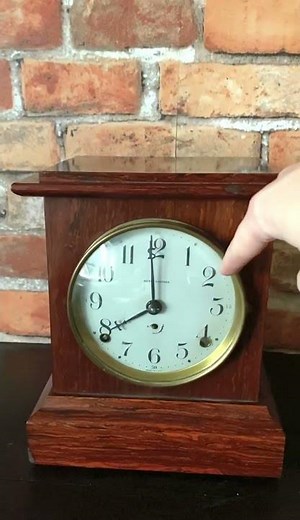 Seth Thomas midcentury 8 day mantel clock. Red wood veneer. Strikes on hour and 1/2 hour.