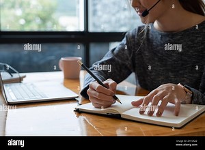 Close up hand of asian woman studying online from home making notes for student distance learning on laptop doing homework, watching listening video Stock Photo - Alamy