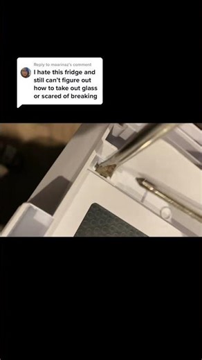 Push the button on the side—glass isn't secure when removing shelf