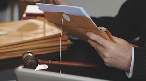 Download A judge's gavel is used to open a file in a courtroom for free