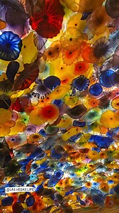 The famous glass ceiling at the Bellagio in Las Vegas, called "Fiori di Como," was created by renowned American glass artist Dale Chihuly. This massive installation features over 2,000 hand-blown glass flowers and was completed in 1998, becoming one of Chihuly's most iconic and recognizable works. | LAS VEGAS LIFE
