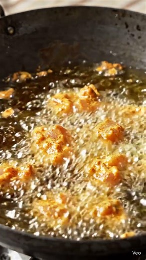 Chicken pakora making marinated chicken coated in gram flour batter deep frying serving with chutney