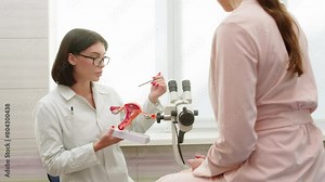 A female patient sits in a gynecological chair during a consultation with the attending gynecologist in a modern clinic after a gynecological examination. Consultations on pregnancy and childbirth.