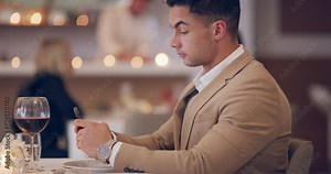 Waiting, restaurant and man with a smartphone, typing and fancy with a glasses, wine and chatting. Person, appointment or date with guy, cellphone or alcohol with mobile user, digital app or patience