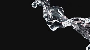 Falling water on a black background - Free Stock Video