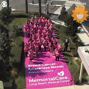 Healthcare workers in masks, including some cancer survivors, formed a human pink ribbon at Long Beach Medical Center in CA Thursday. October is #BreastCancerAwareness month. The hospital said the event was to remind people of the importance of preventative screenings. | CBS Sunday Morning