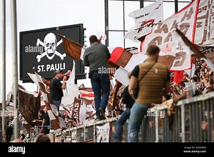 Hamburg, Germany. 03rd Oct, 2021. Football: 2nd Bundesliga, Matchday 9, FC St. Pauli - Dynamo Dresden, at Millerntor Stadium. St. Pauli's fans celebrate their team's 3:0 victory after the final whistle. Credit: Christian Charisius/dpa - IMPORTANT NOTE: In accordance with the regulations of the DFL Deutsche Fußball Liga and/or the DFB Deutscher Fußball-Bund, it is prohibited to use or have used photographs taken in the stadium and/or of the match in the form of sequence pictures and/or video-like