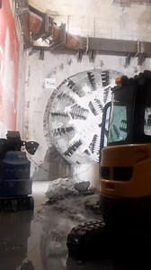 Tunnel Boring Machine (TBM) tunnelling is a method used for excavating tunnels through various types of soil and rock. TBMs are large, specialised machines designed to bore through the ground, minimising the need for manual excavation. They consist of a rotating cutterhead at the front, which breaks and removes the material, while the tunnel is simultaneously lined with concrete segments or other structural materials to support the tunnel walls. TBM tunnelling is commonly used in construction pr