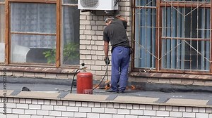 Worker Repairing Lay Hot Tar On Roof Surface With Special Tools And Flame Stock Video