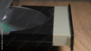 inserting a disc into the DVD player, starting the DVD player, turning on a movie on the DVD player, old technology, Slow motion