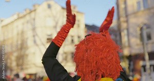 Carnival - Cheerful, costumed woman dancing and clapping her hands. Handheld shot. Shallow depth of field. Slow-mo.
