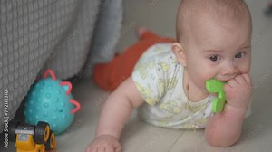 Baby exploring all around the house, 7 month old baby boy crawling, touching everything. Baby learning to crawl and play on the floor with a toys.