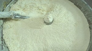 Flour dough making machine. Dough making process for making ravioli. Automatic production of dumplings. Food industry, food production. 4K video shooting.