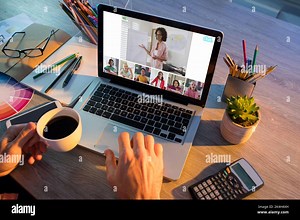 Hands of man using laptop for video call, with smiling diverse elementary school pupils on screen. communication technology and online education, digi Stock Photo - Alamy