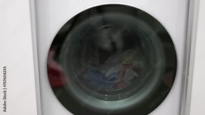 Close up view of a modern washing machine in operation, showcasing the laundry process.