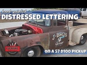 Hand-painted distressed lettering on 57 D100 truck doors