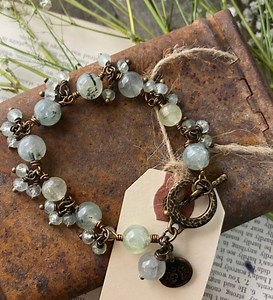 Wire wrapping my prehnite stone bracelet. Bracelet and kit are available in the shop. This was published in a magazine in 2023. With 22 g antique brass wire from @artisticwirebrand 8 mm And 4 mm prehnite stone from @tejasbeads Tools from @beadalon 💚YouTube tutorial available on my channel on how to create this bracelet! 💚Bracelet is available at ⤵️Andria Bieber Designswww.andriabieberdesigns.com💚.#jewelry #andriabieberdesigns #handmadejewelry #handcraftedjewelry #beadedjewelry #jewelrydesigne