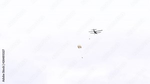 Military parachutists jump from the plane. Jumping with a parachute at low altitude