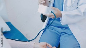 Doctor use stethoscope, checking up heart beat, auscultation in doctor office at hospital. Patient worker has to get medical checkup every year for her health or medical checkup cardiologist.