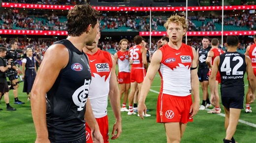 Ollie Florent and Callum Mills embrace after AFL game