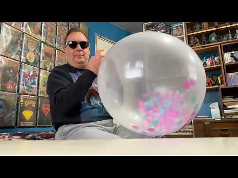 Blowing up a big 24” clear balloon with confetti inside.