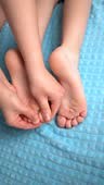 Children's therapeutic foot massage at home, body care concept,...