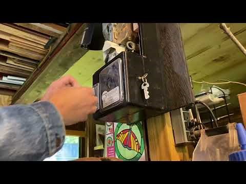 Unlocking a pay phone and accessing the mount screws.